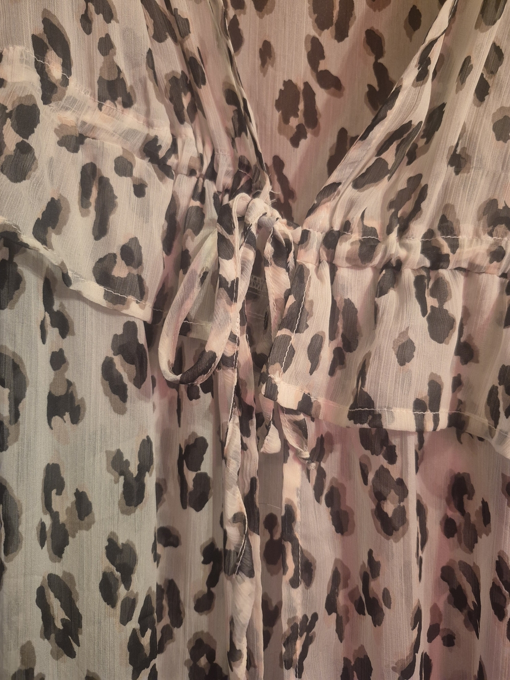 Express kimono features a distinctive sheer leopard print pattern.